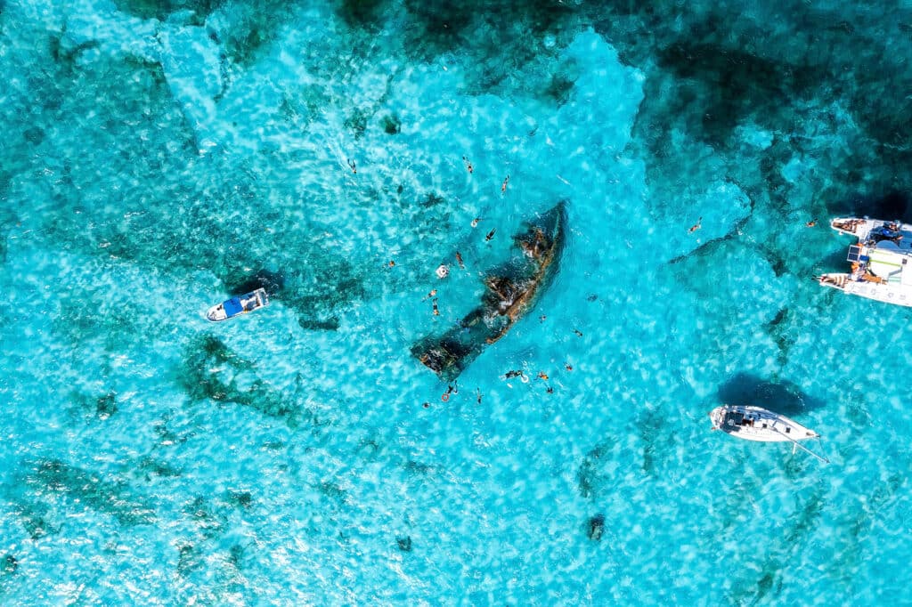 People Snorkelling Around The Ship Wreck Near Cancun In The Cari